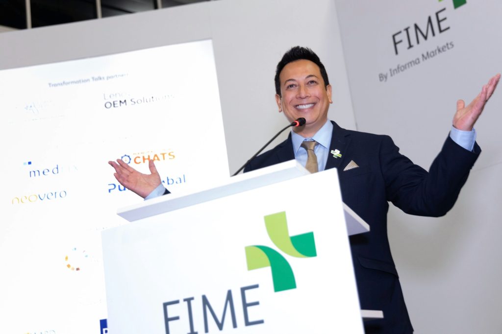 Kenneth C. Wong, MBA, FACHE, welcoming the audience as emcee at an international healthcare conference