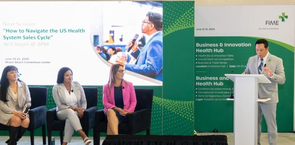 Kenneth C. Wong moderating a panel on the U.S. health system sales cycle at WHX Miami 2024