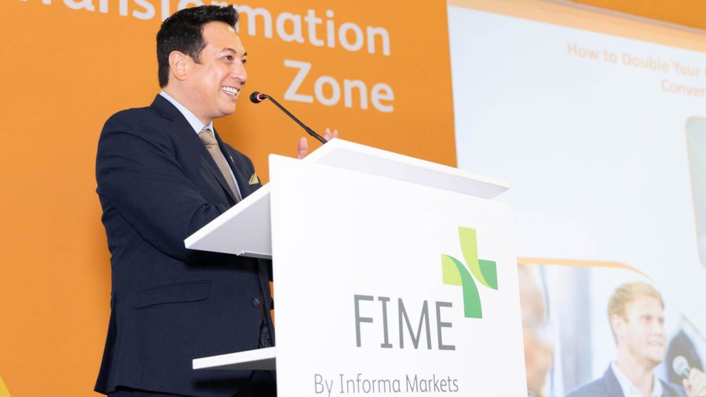Kenneth C. Wong emceeing the Transformation Zone at FIME 2023